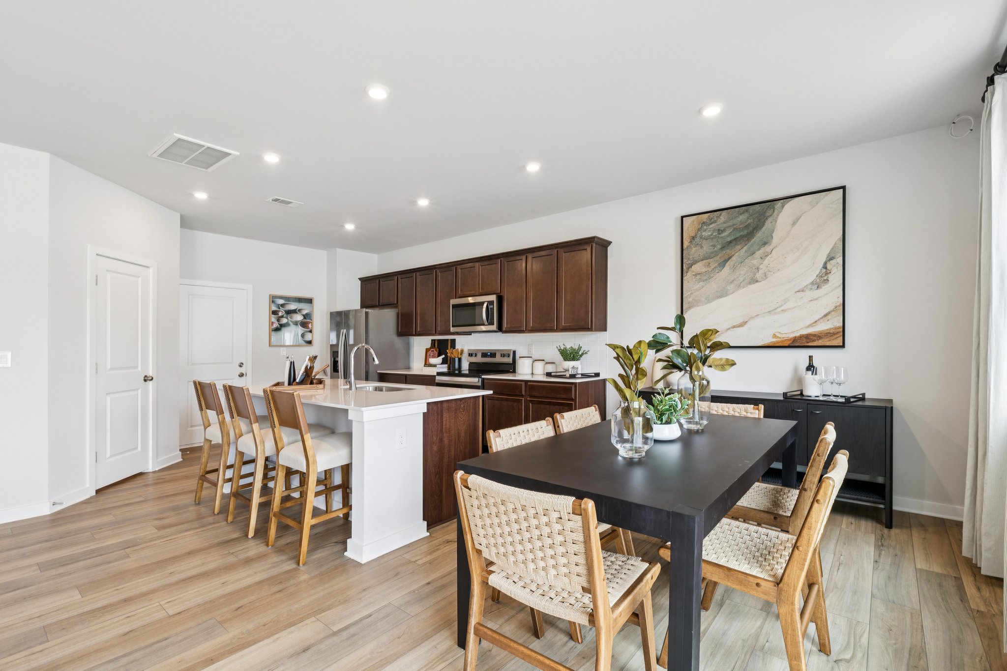 A kitchen with a dining table.