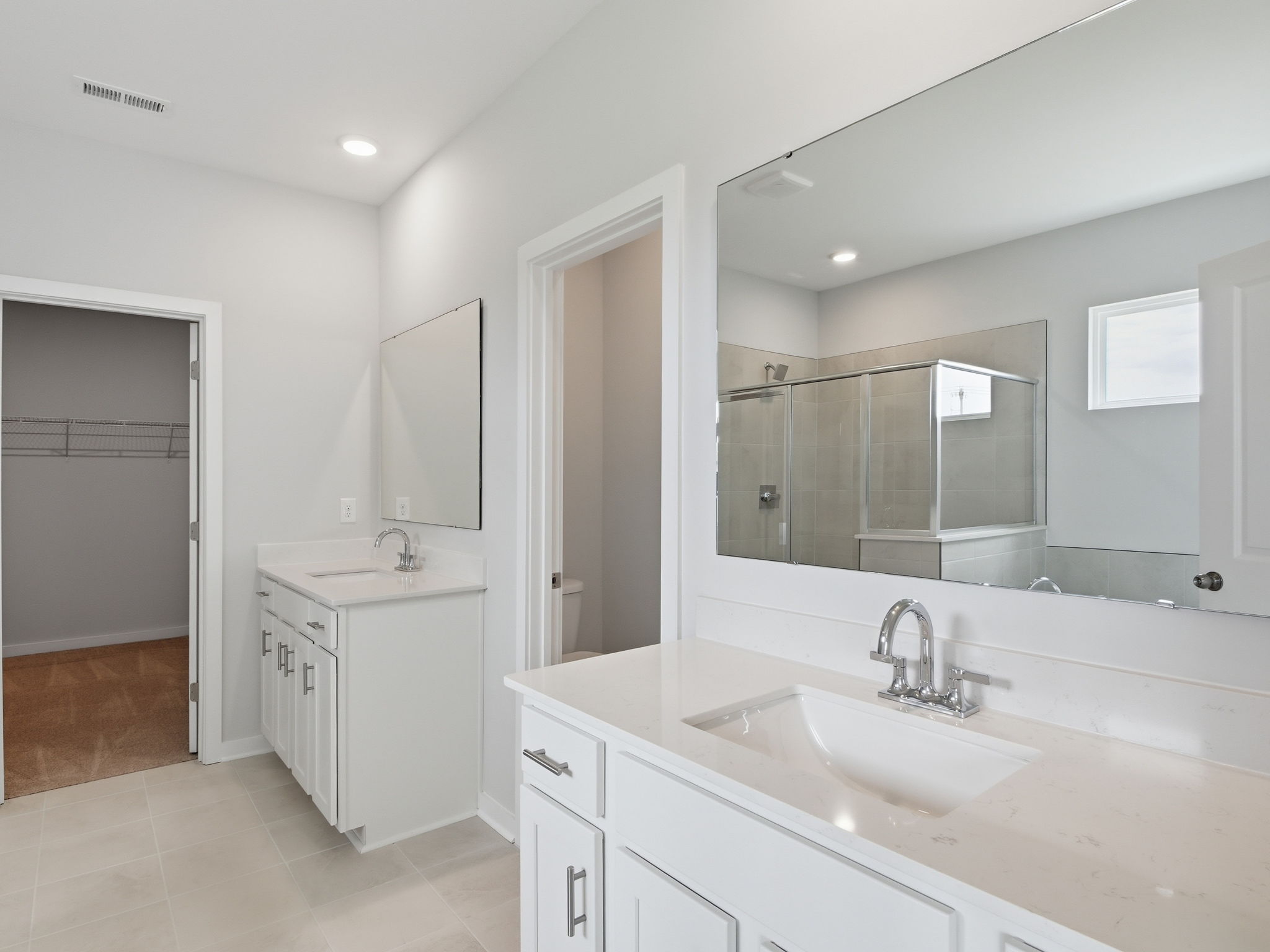 A bathroom with a large mirror.