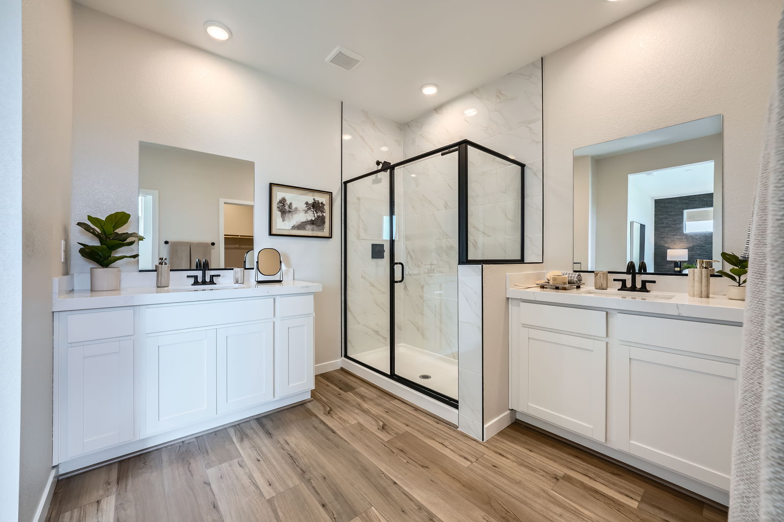 A bathroom with white cabinets.