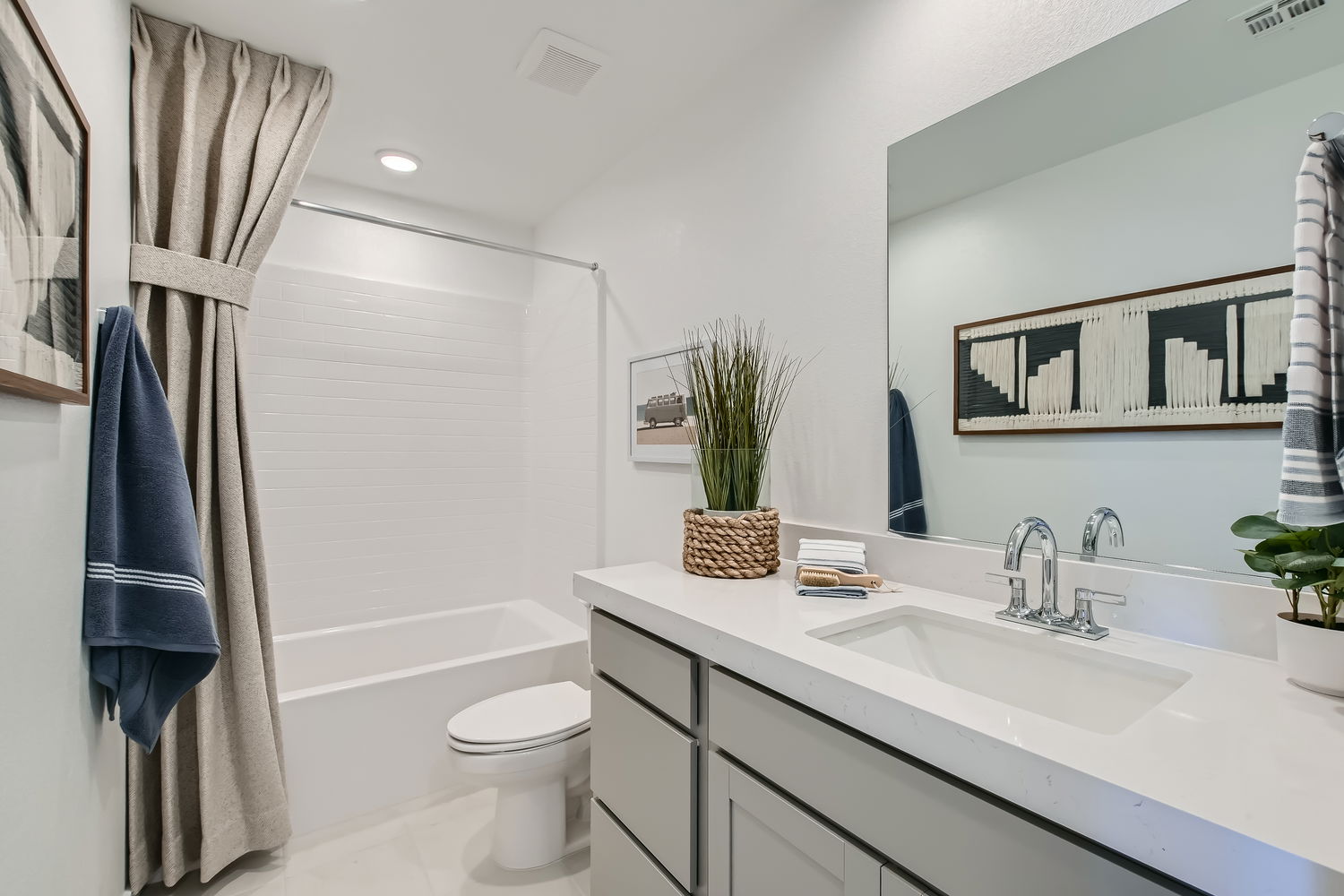 A bathroom with a sink toilet and a bathtub.