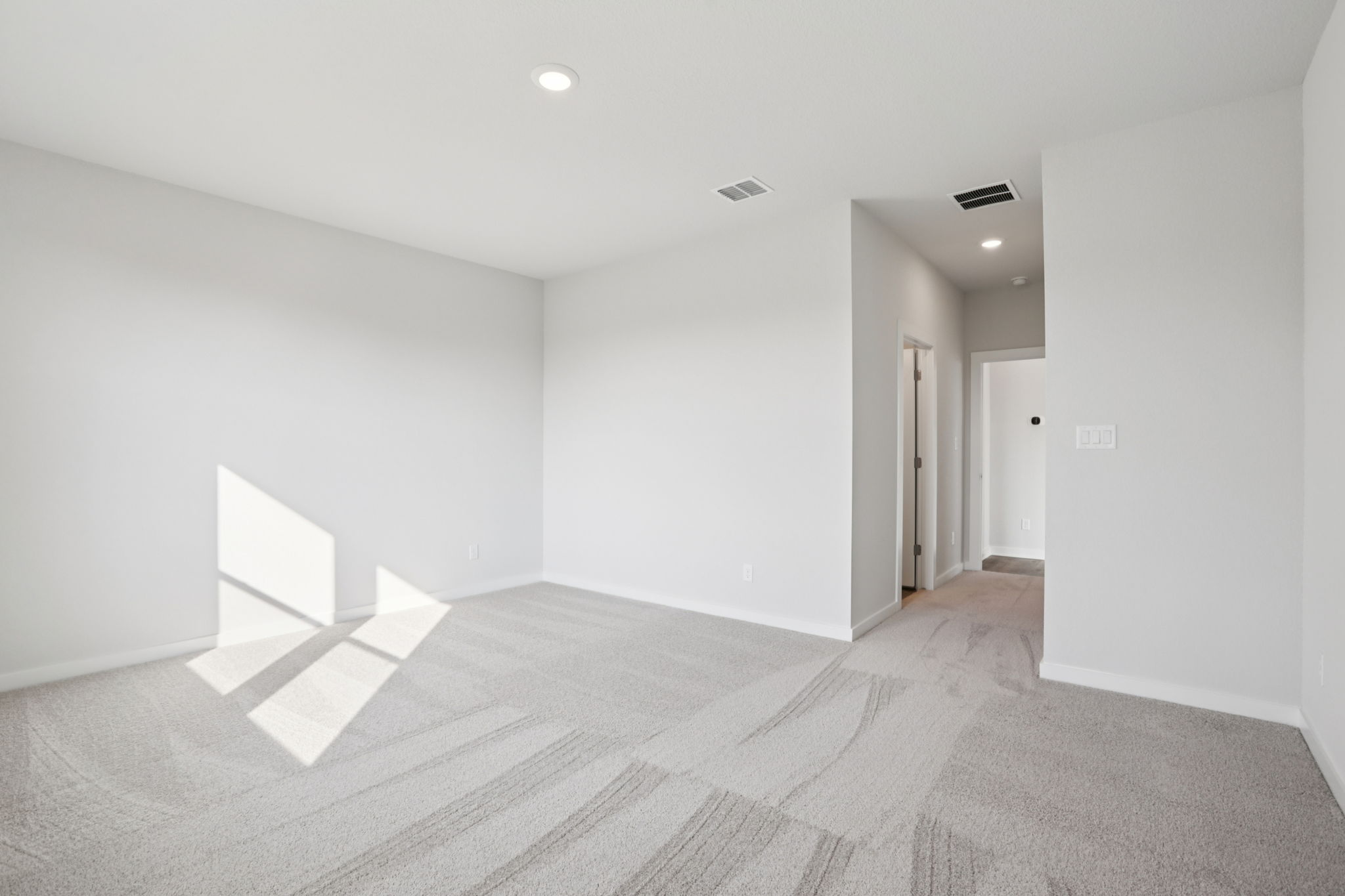 A room with a bed and a rug.