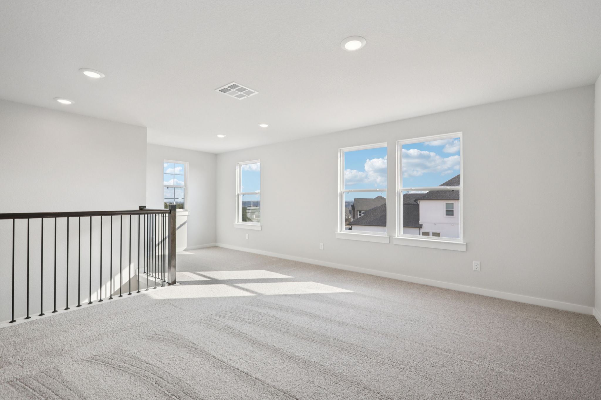 A large white room with a railing.