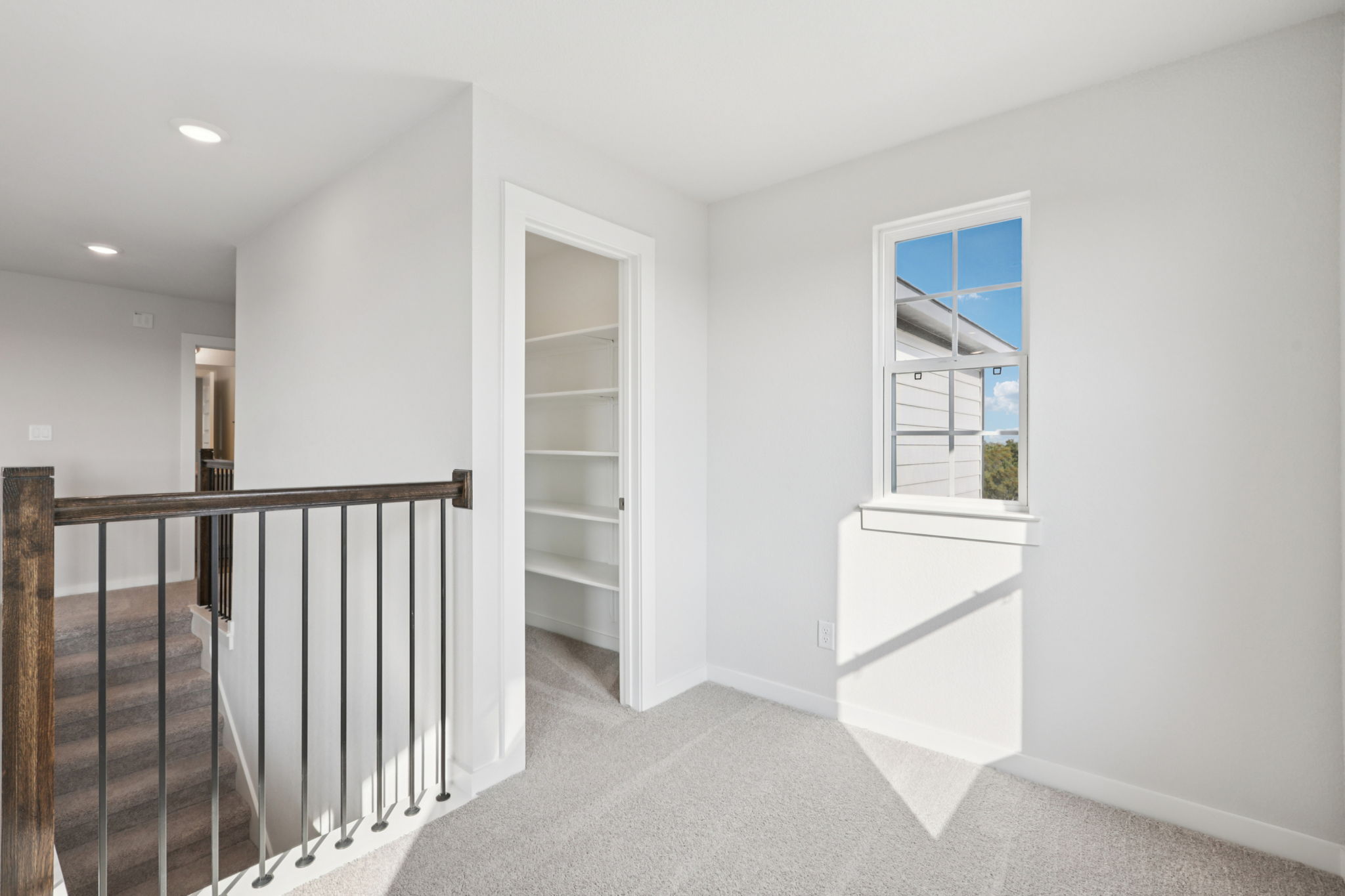 A white room with a staircase.