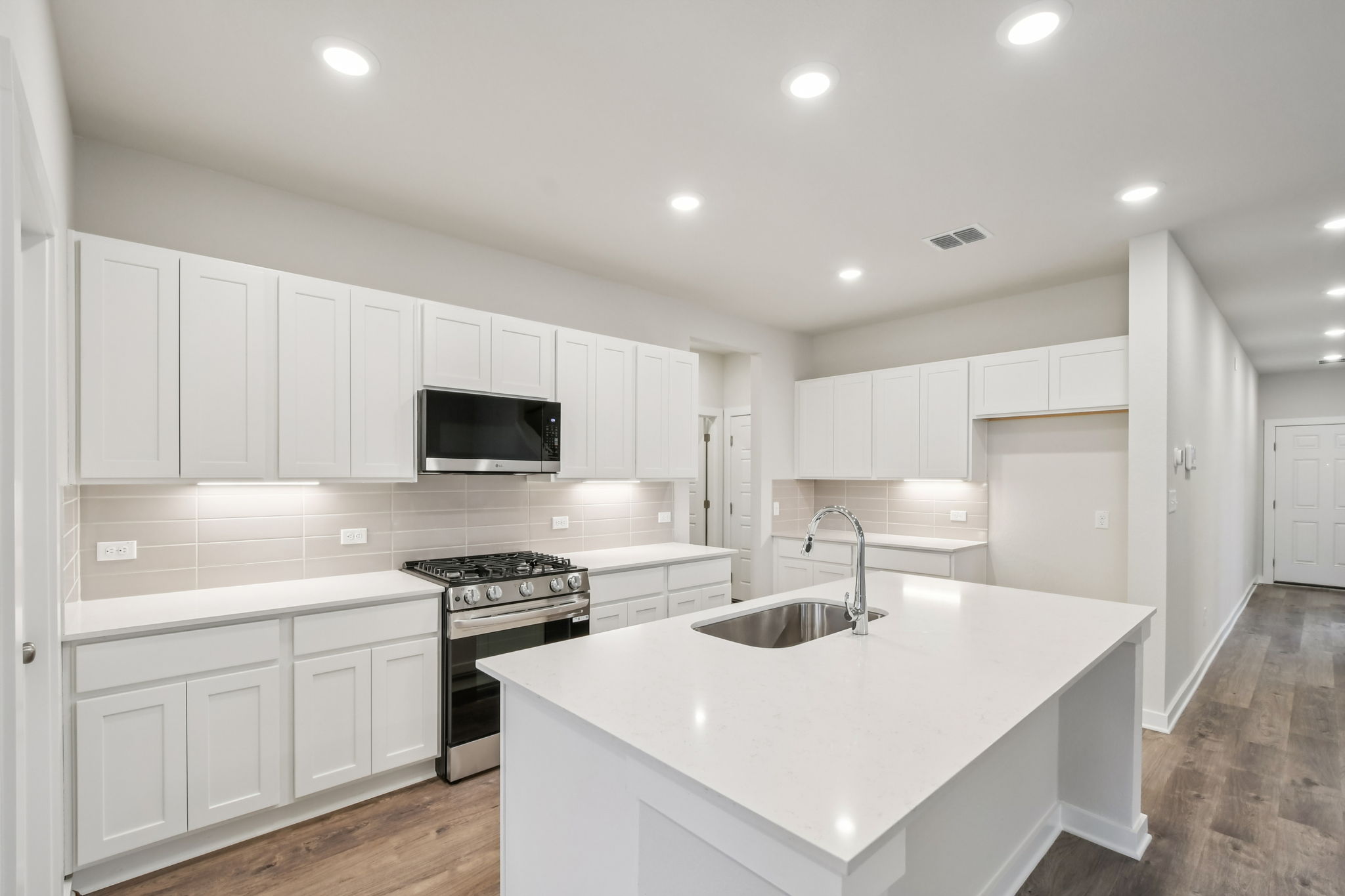 A kitchen with white cabinets.