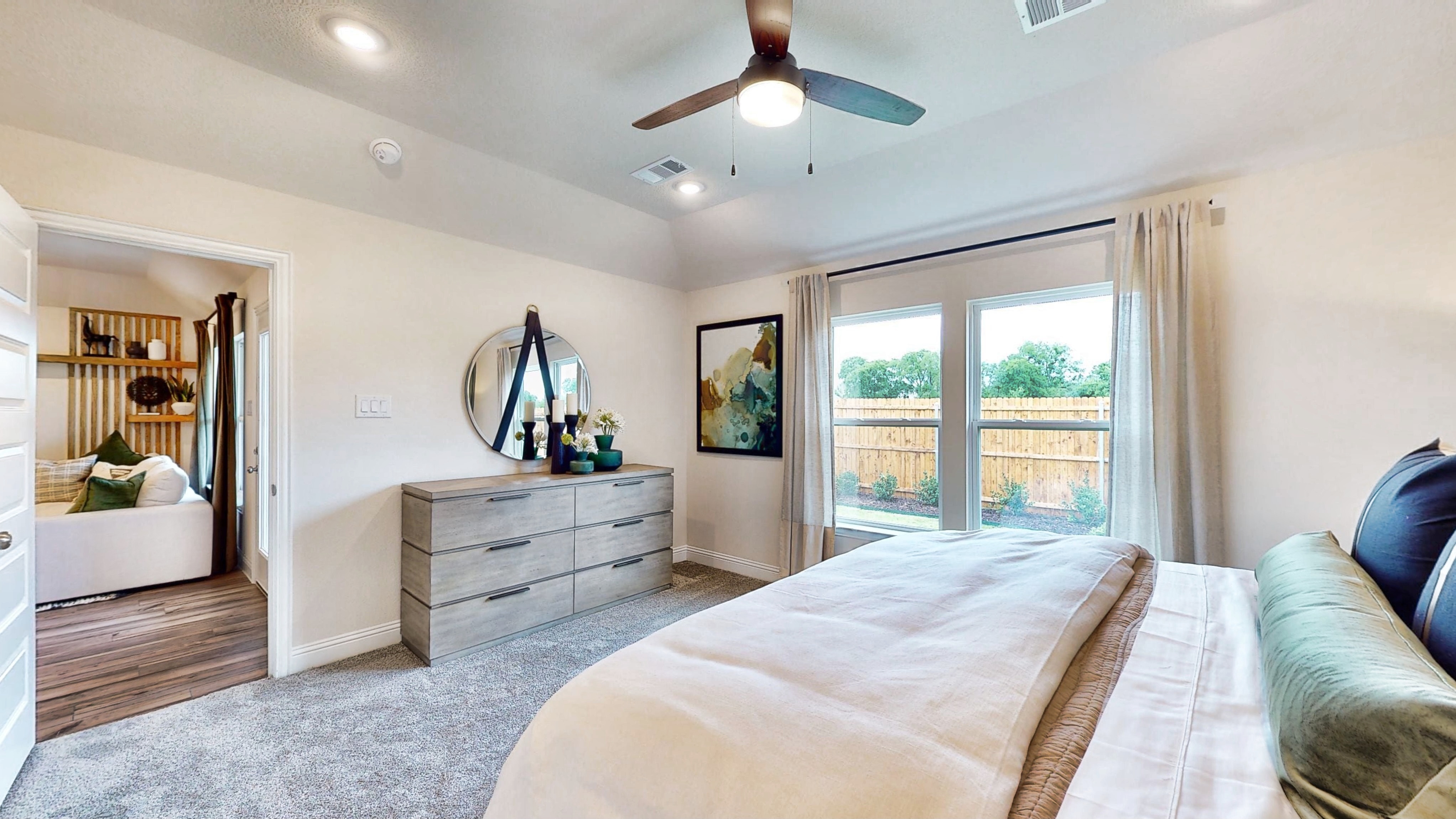 A bedroom with a large window.