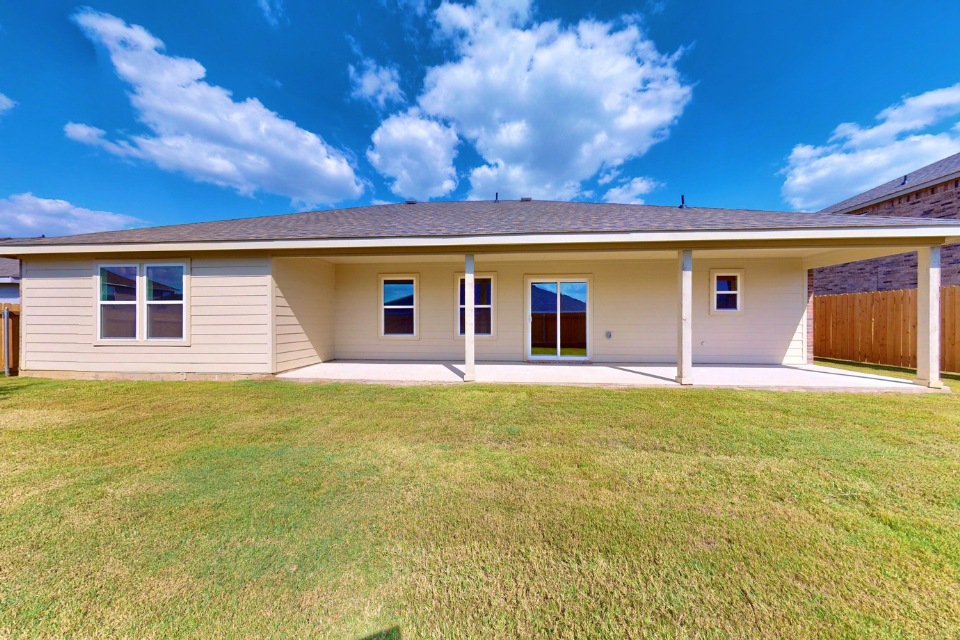 A house with a lawn in front of it.