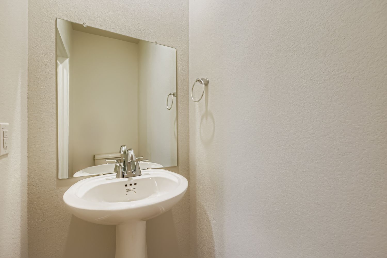 A bathroom with a mirror and sink.