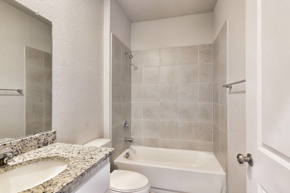 A bathroom with a marble countertop.
