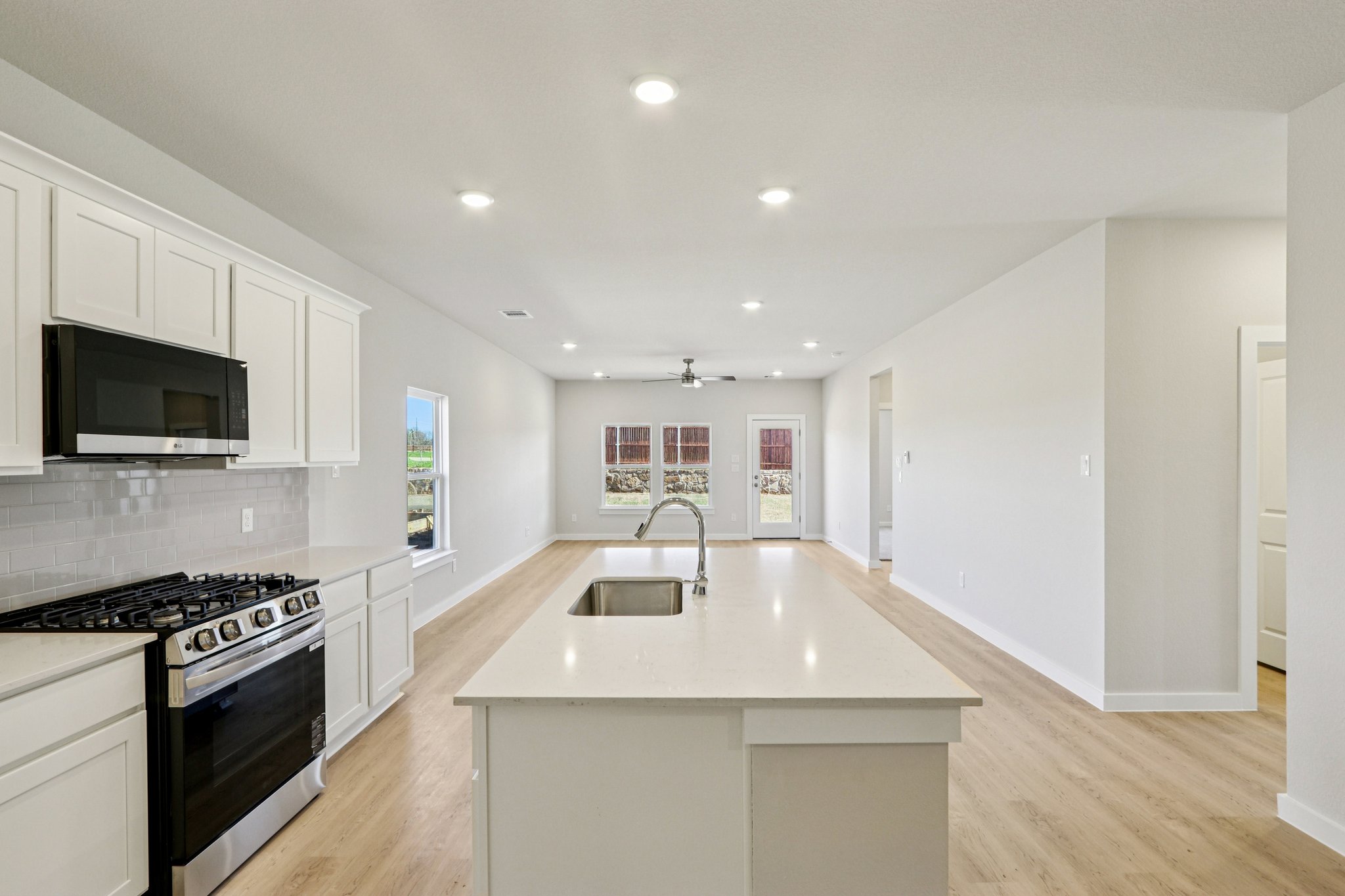 A kitchen with white cabinets.