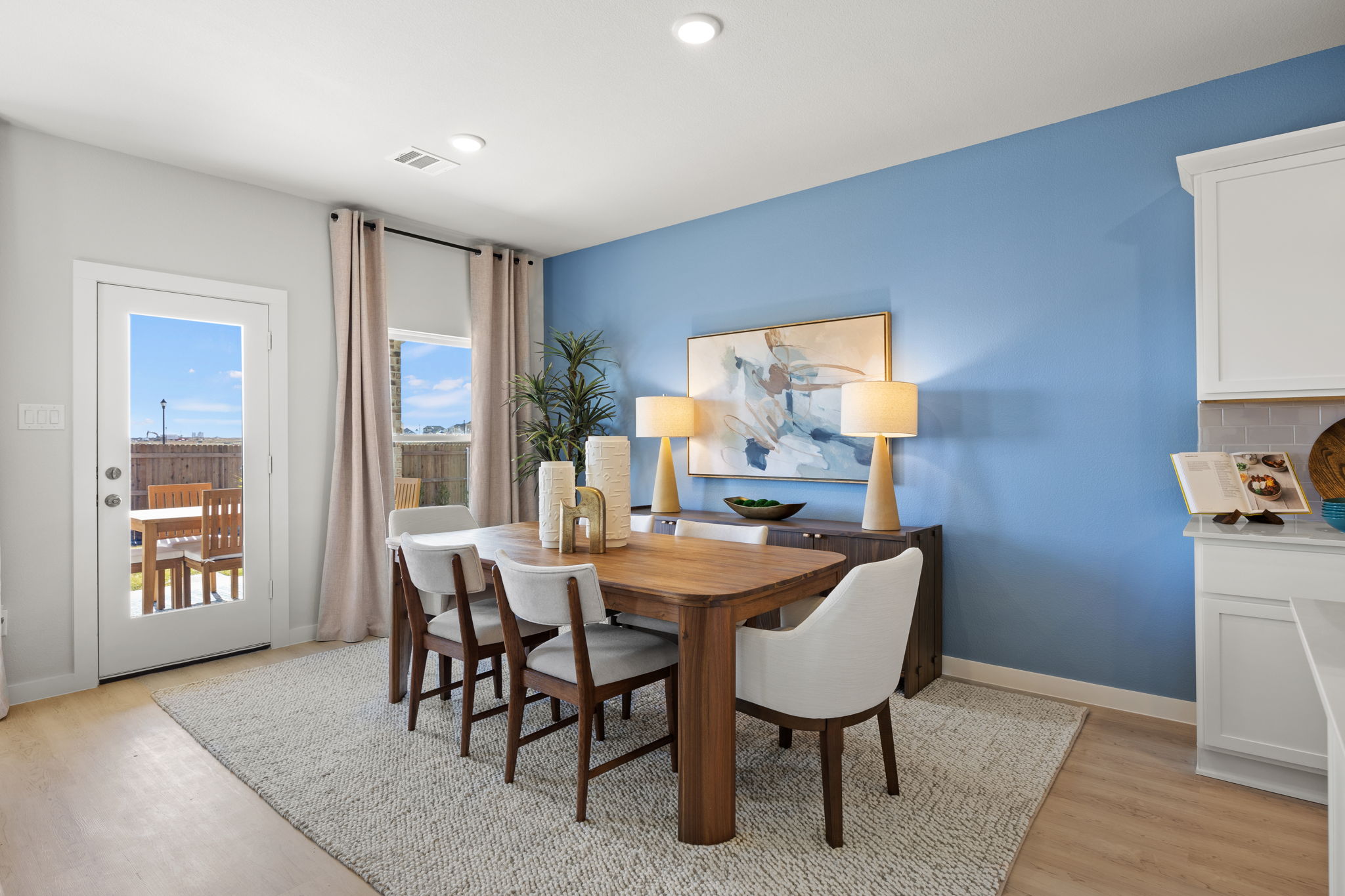 A dining room with a table and chairs.