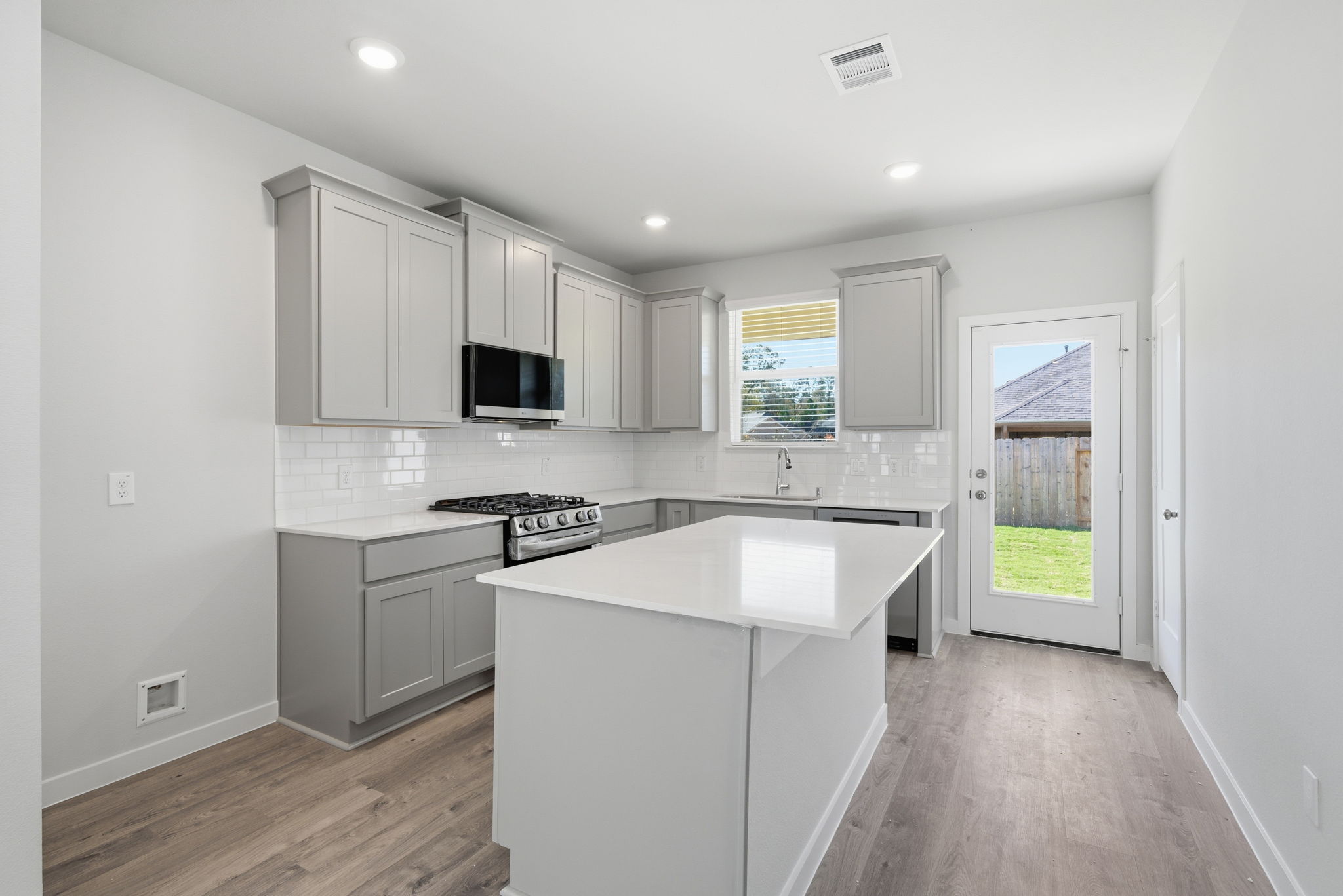A kitchen with white cabinets.