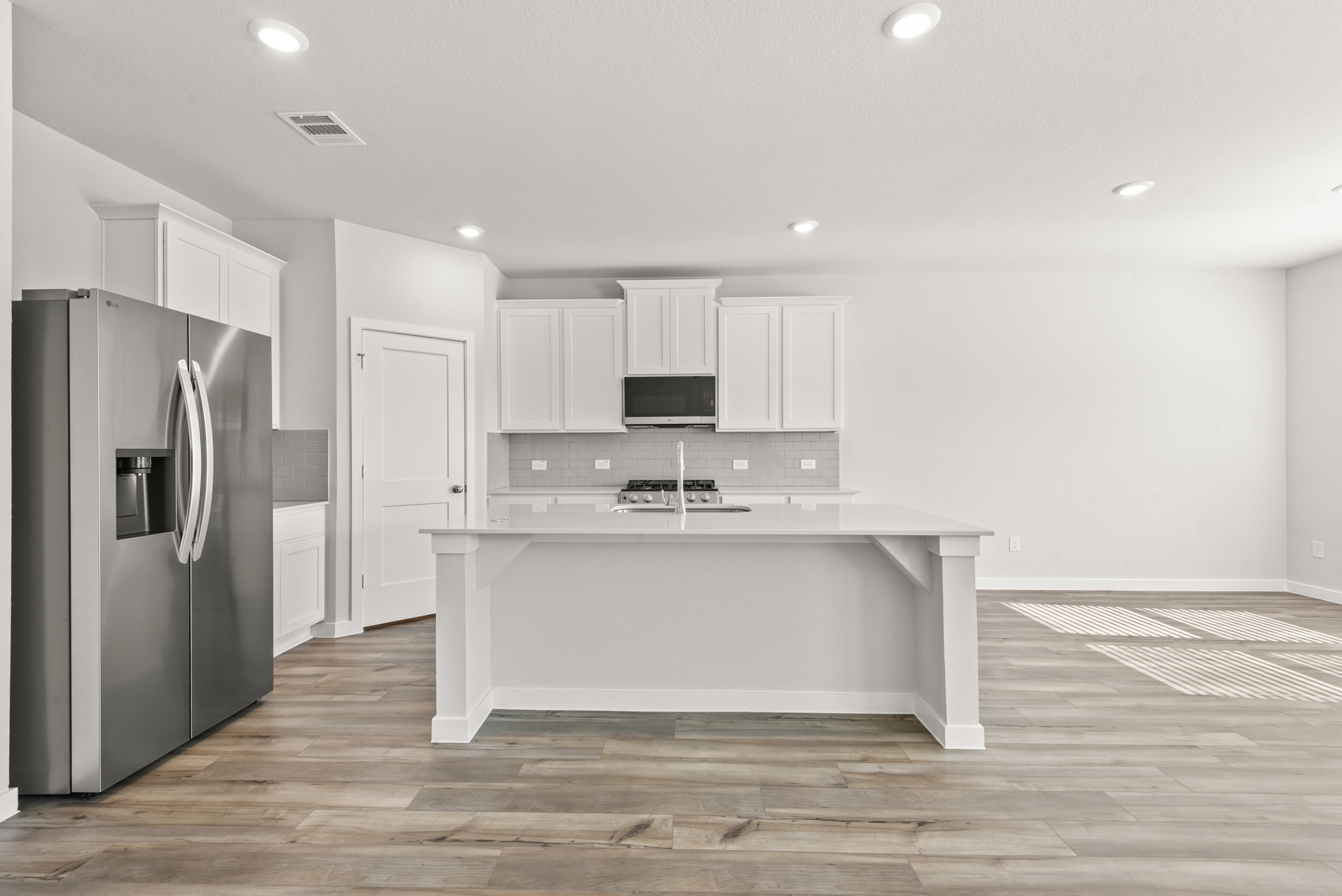 A kitchen with white cabinets.