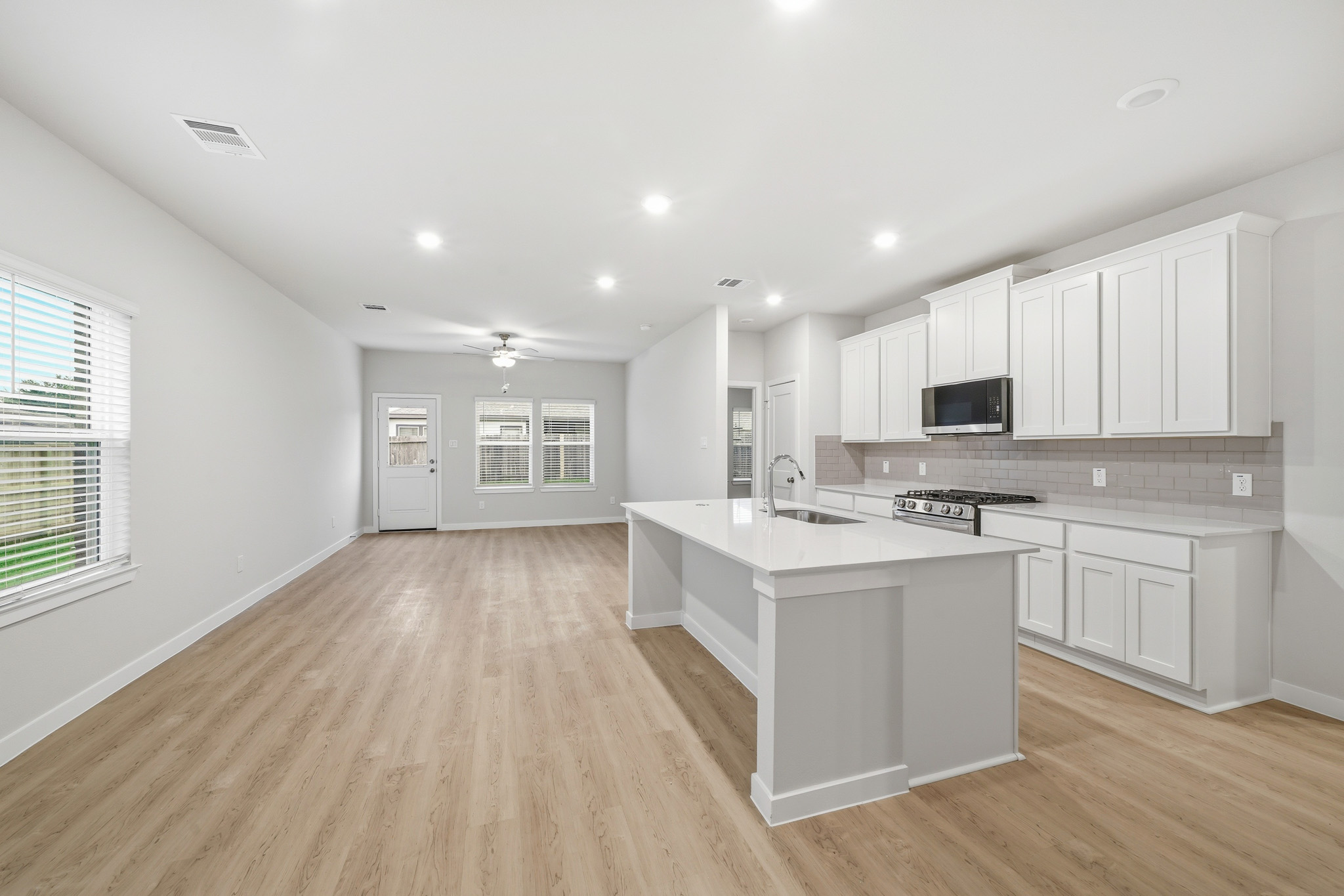 A kitchen with white cabinets.