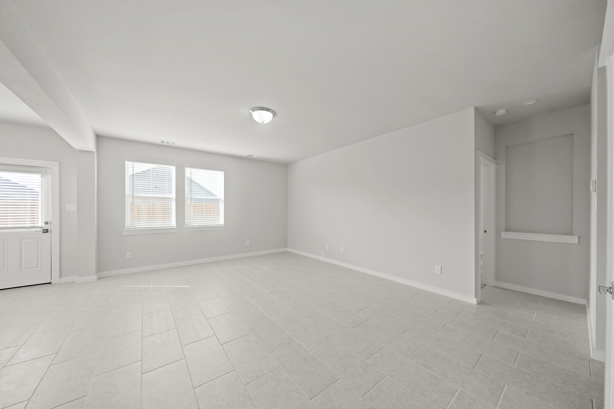 A room with white walls and windows.