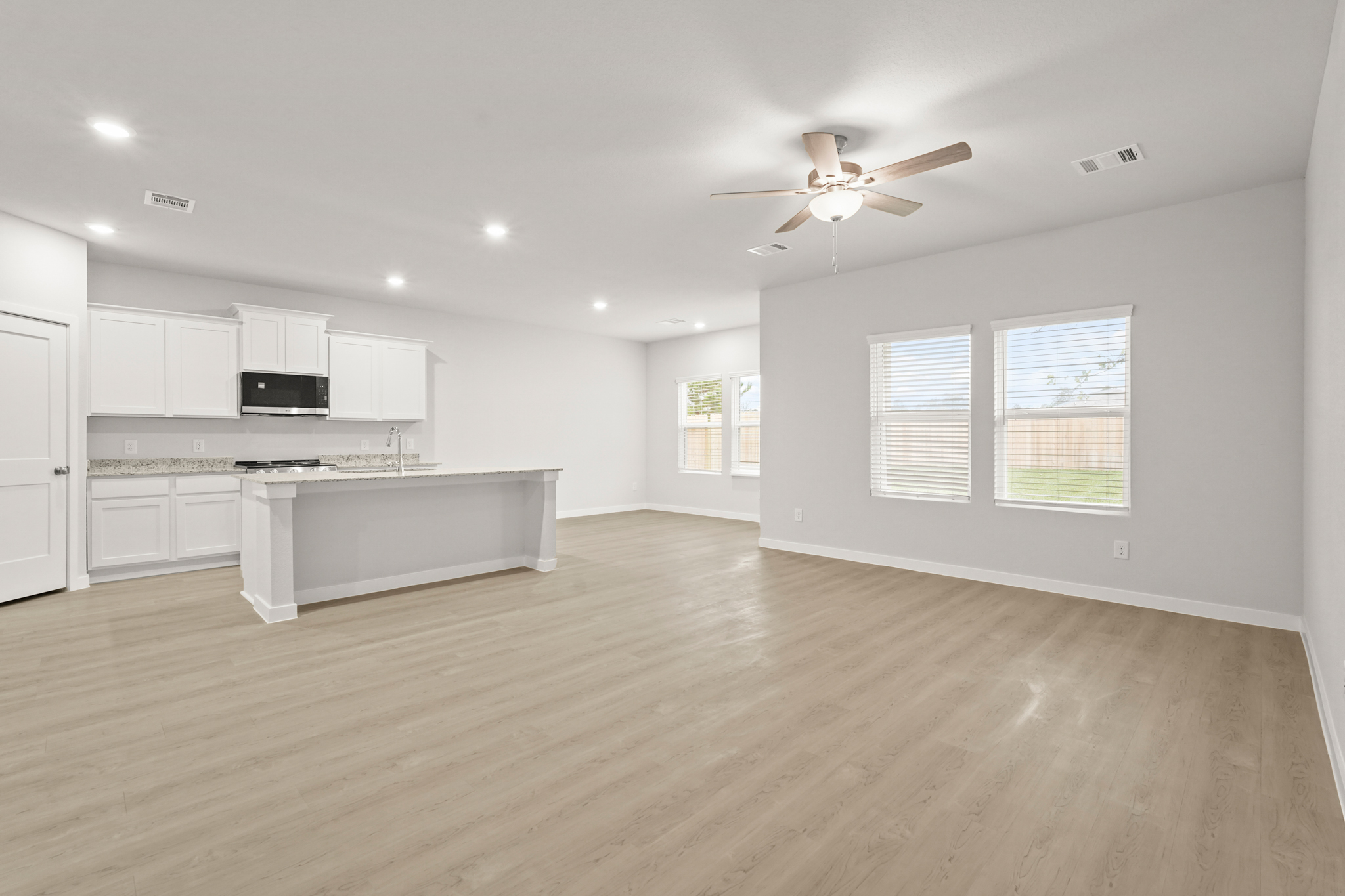 A large kitchen with white cabinets.