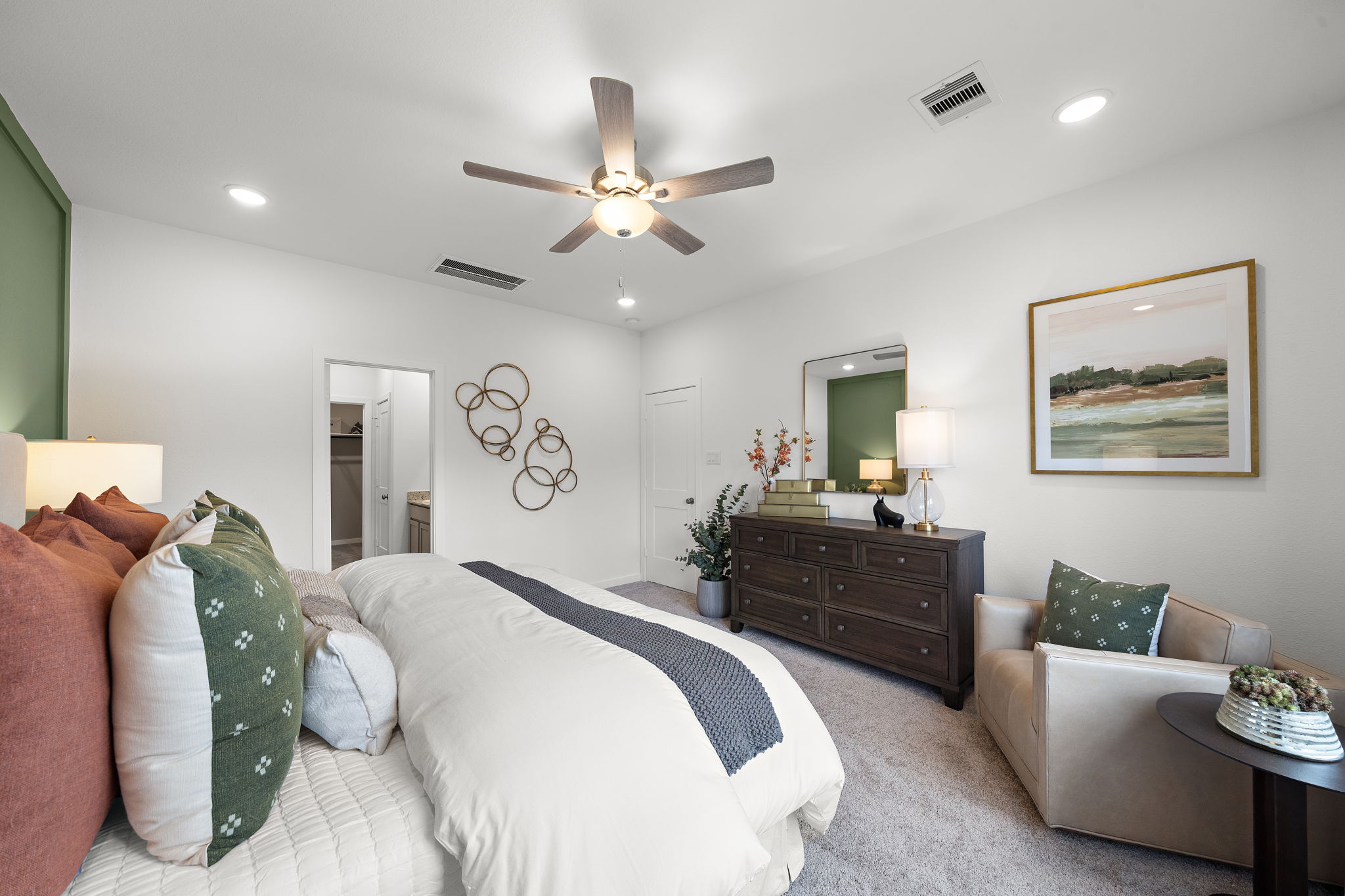 A bedroom with a bed and a fan.