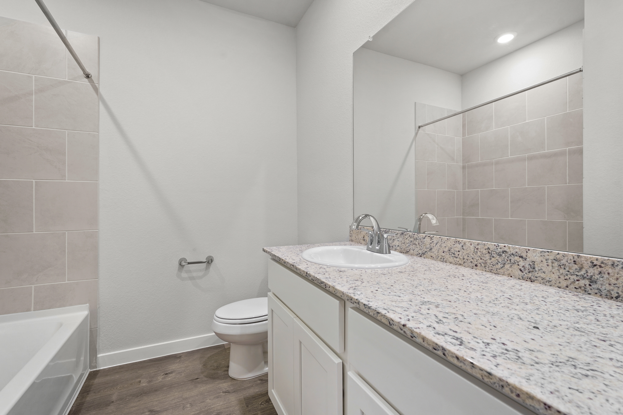 A bathroom with a marble countertop.