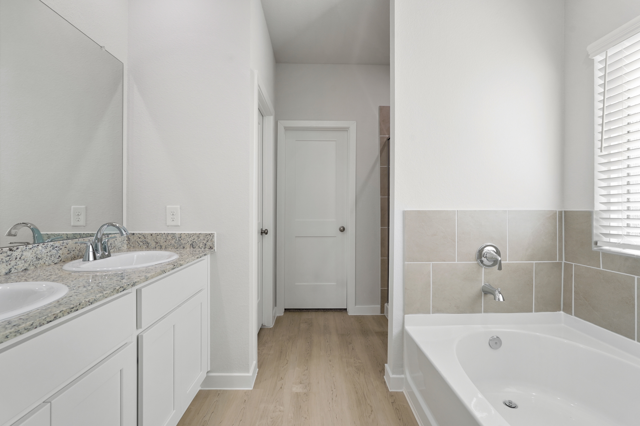A bathroom with a tub sink and a bathtub.