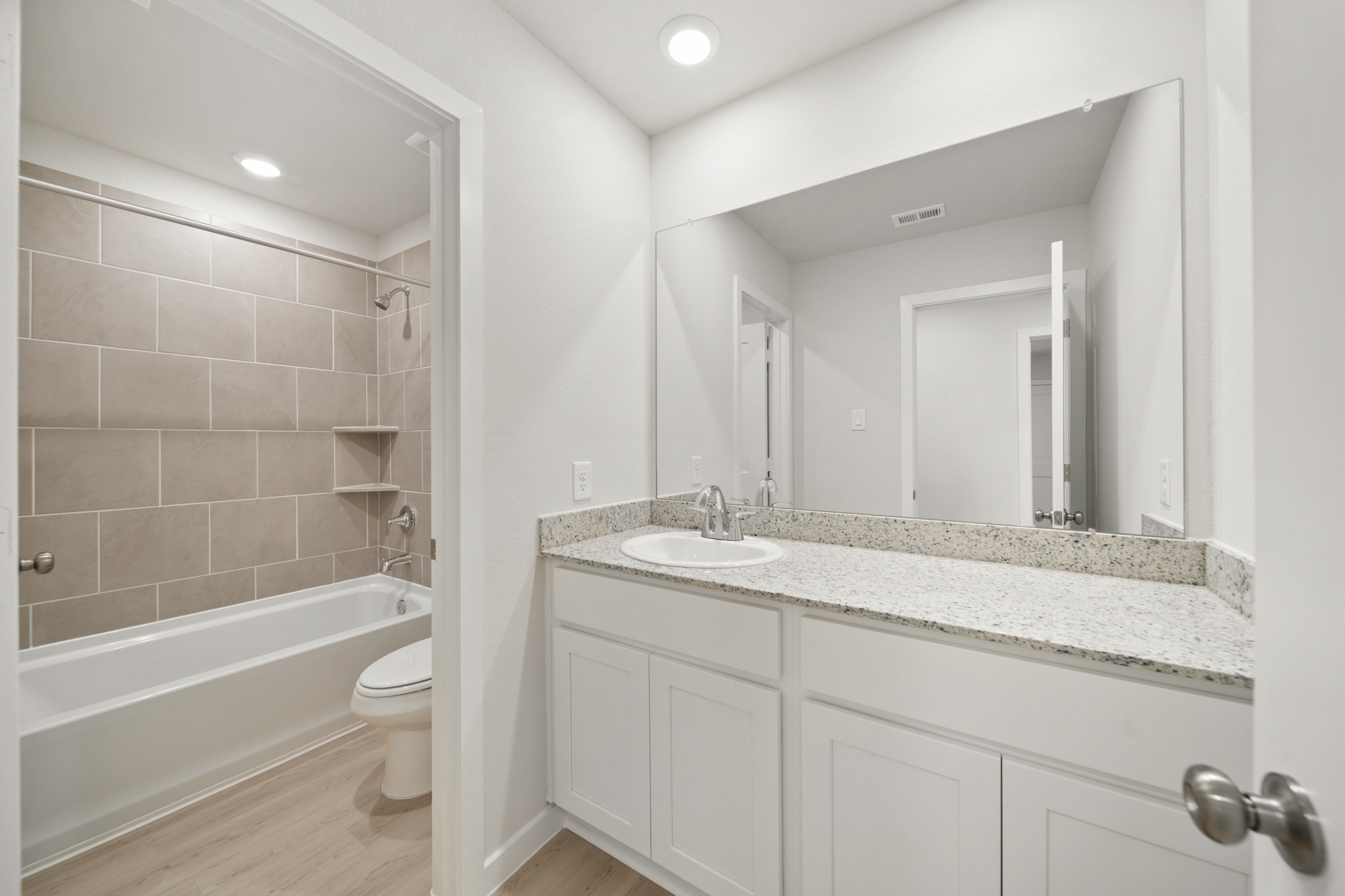 A bathroom with a marble countertop.
