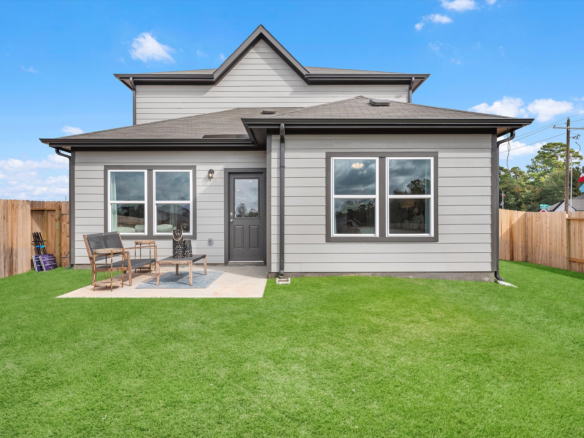 A house with a yard and a fence.