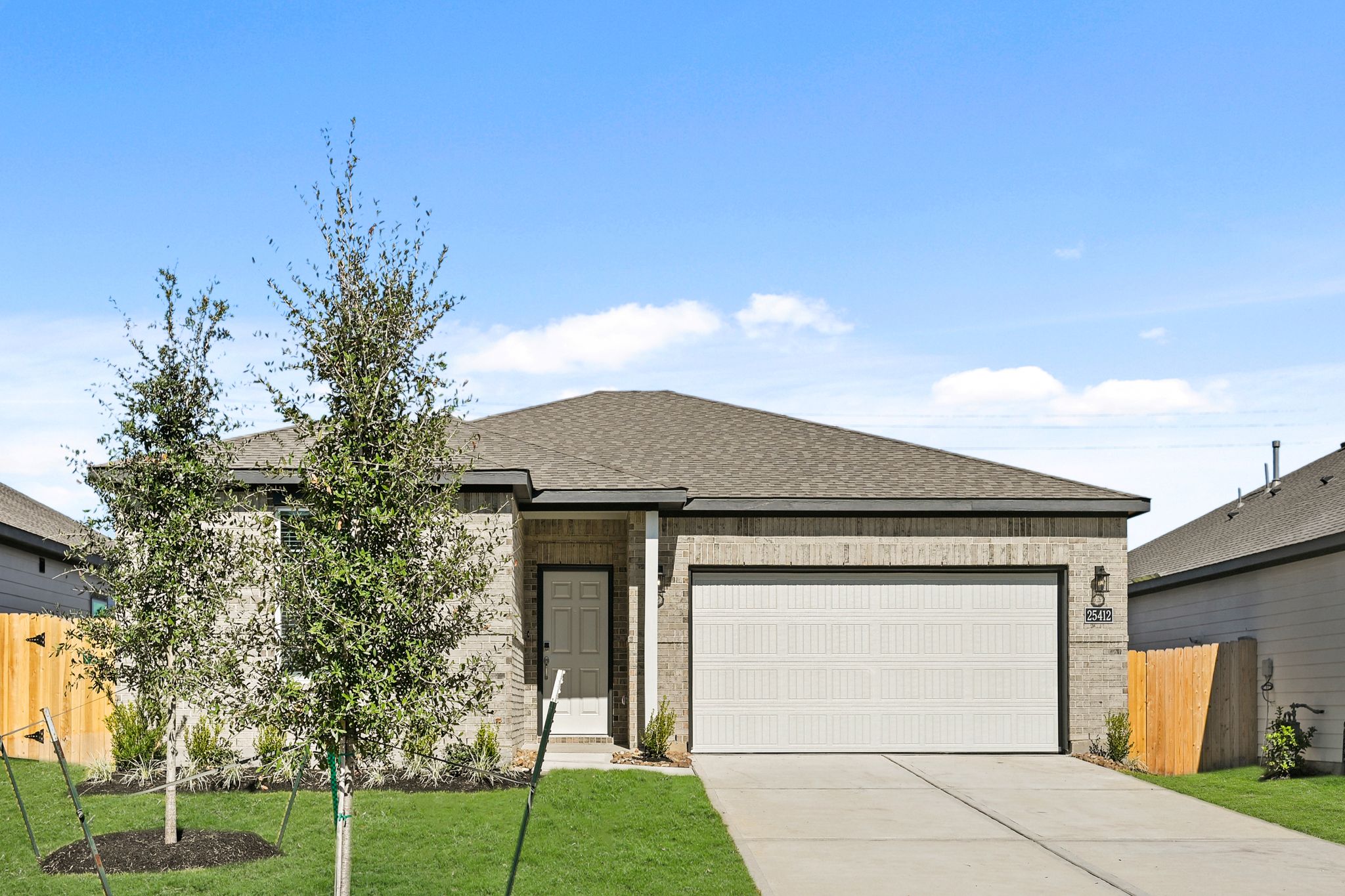 A house with a garage and trees.