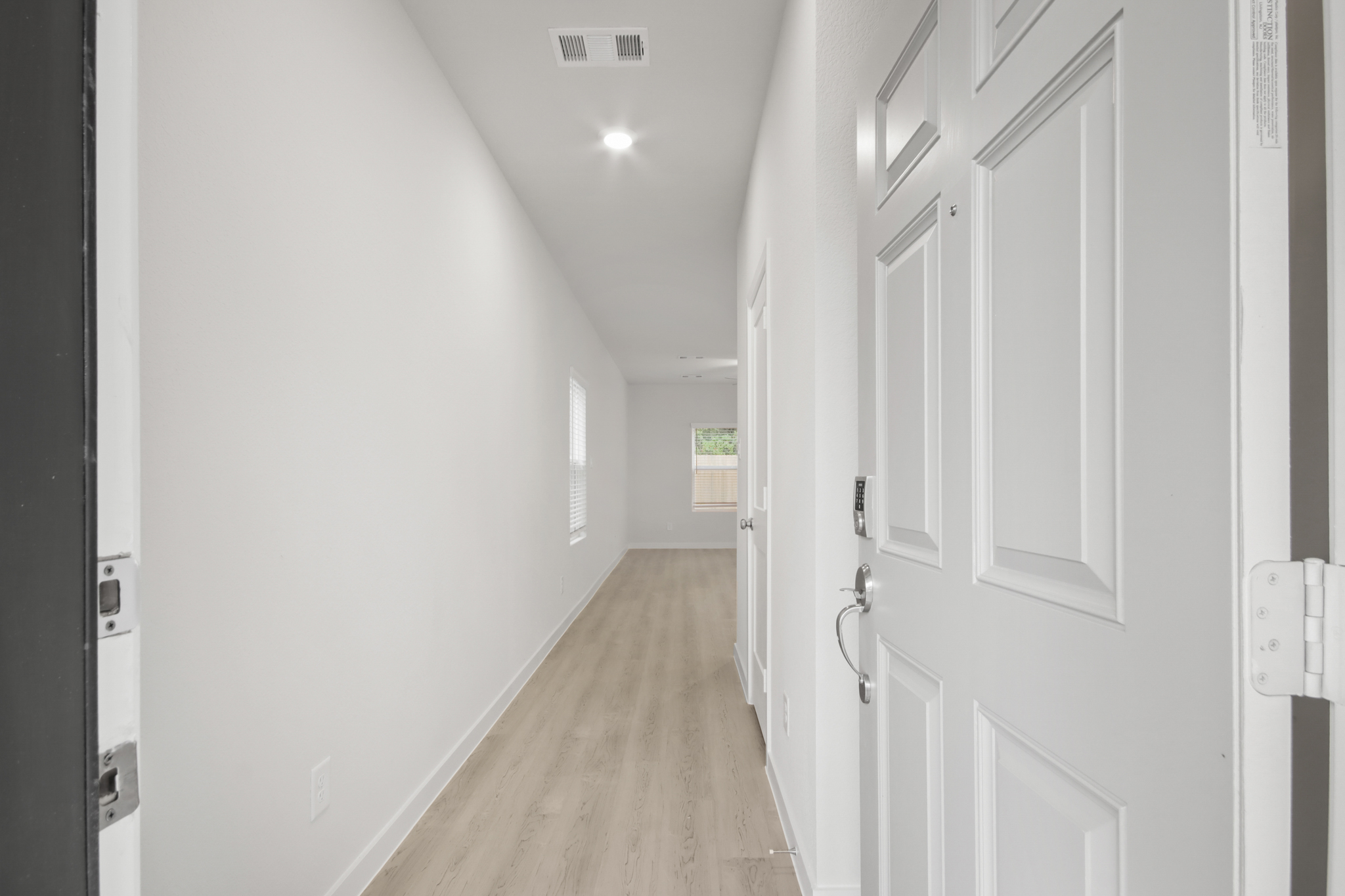 A hallway with white doors.