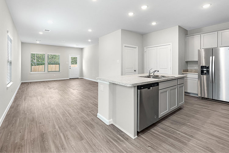 A kitchen with white cabinets.