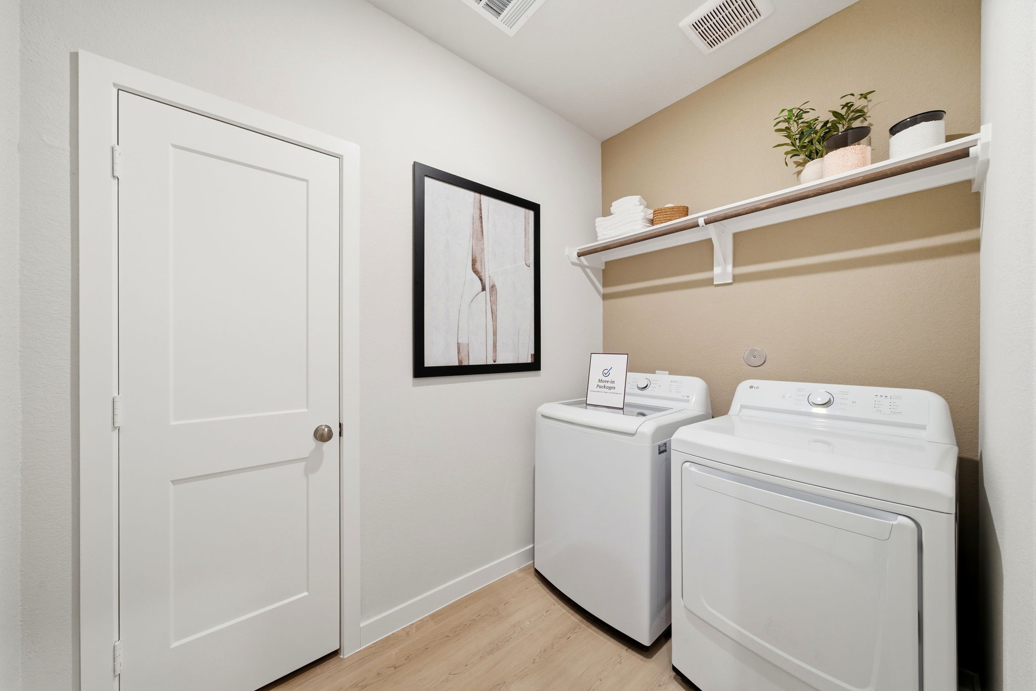 A room with a washer and dryer.