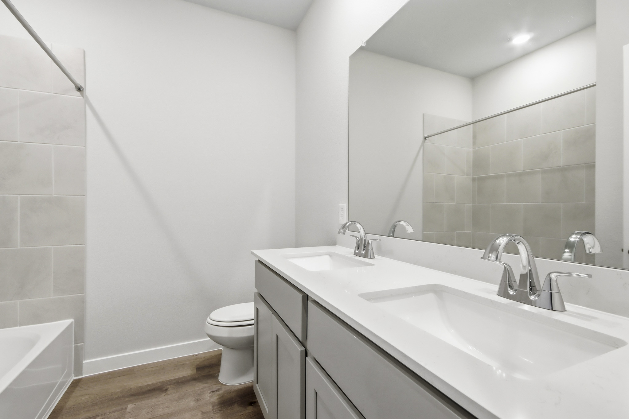 A bathroom with a large mirror.