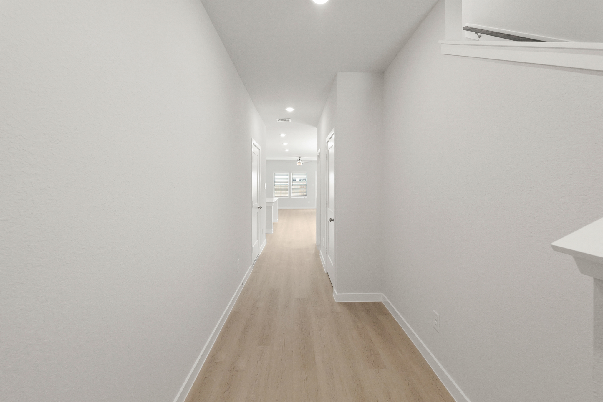 A long hallway with white walls.