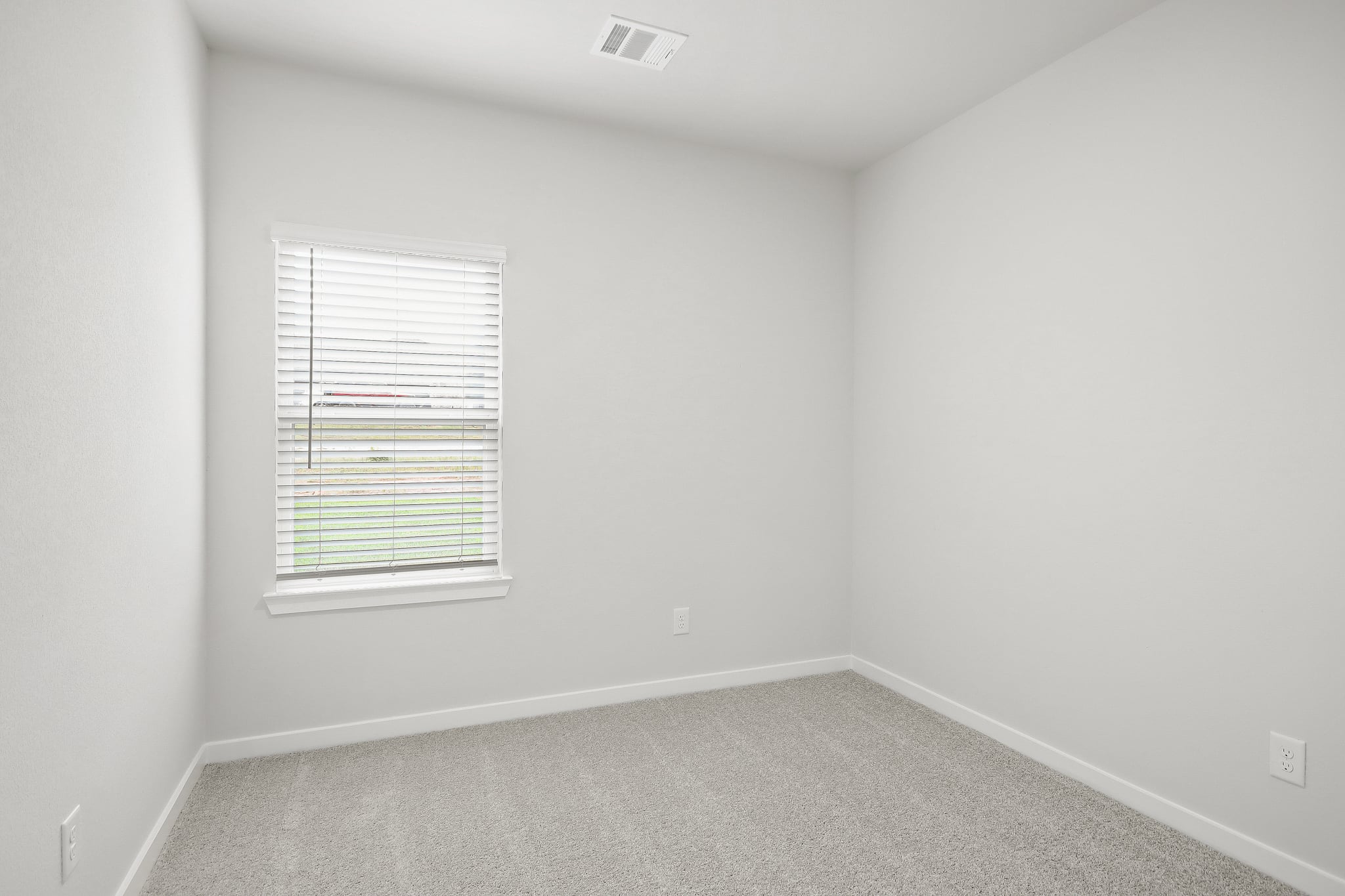 A room with a window and a vent.