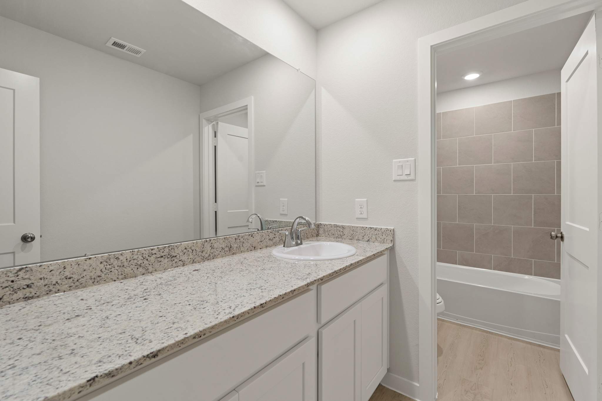 A bathroom with a marble countertop.
