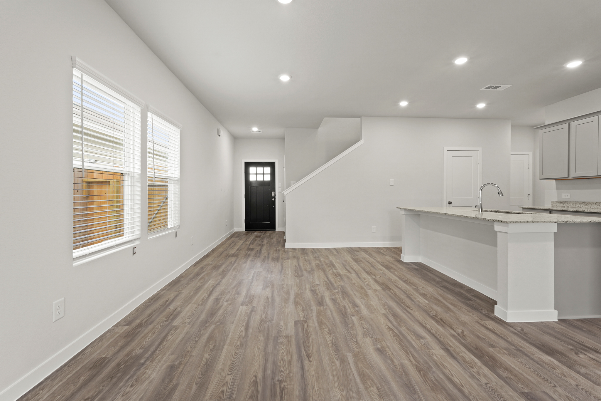 A kitchen with white cabinets.