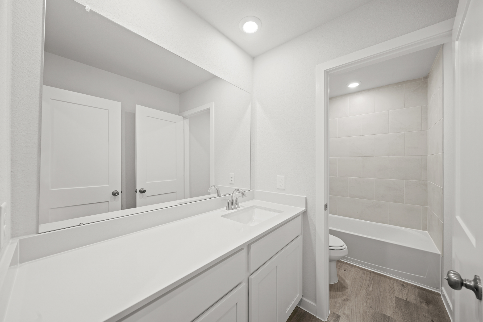 A bathroom with a tub sink and toilet.