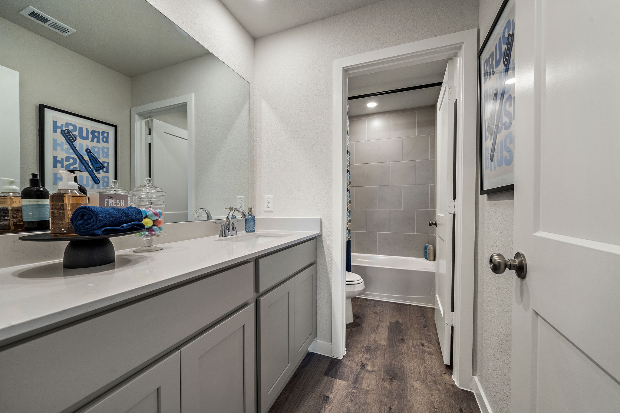 A bathroom with a tub sink and toilet.