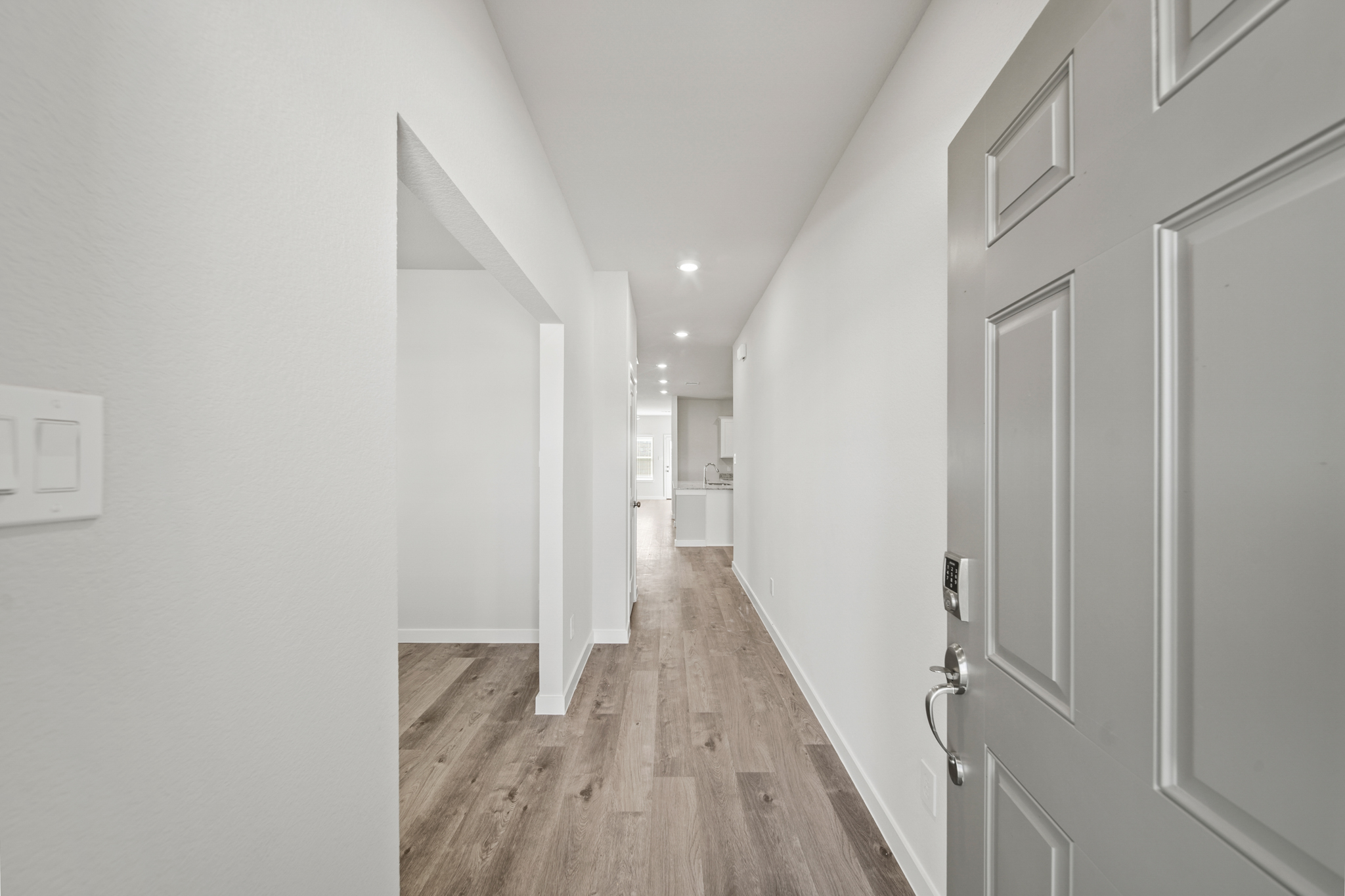 A hallway with white doors.