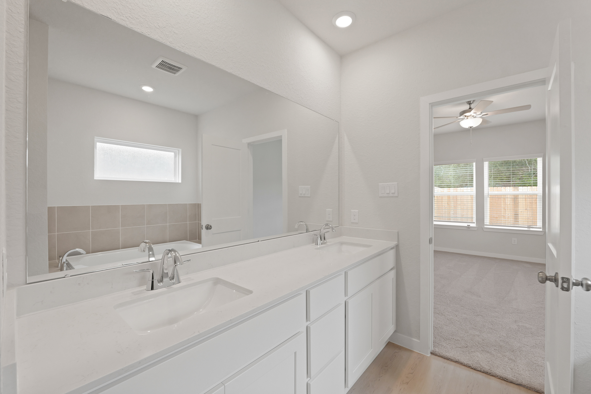 A bathroom with a large mirror.