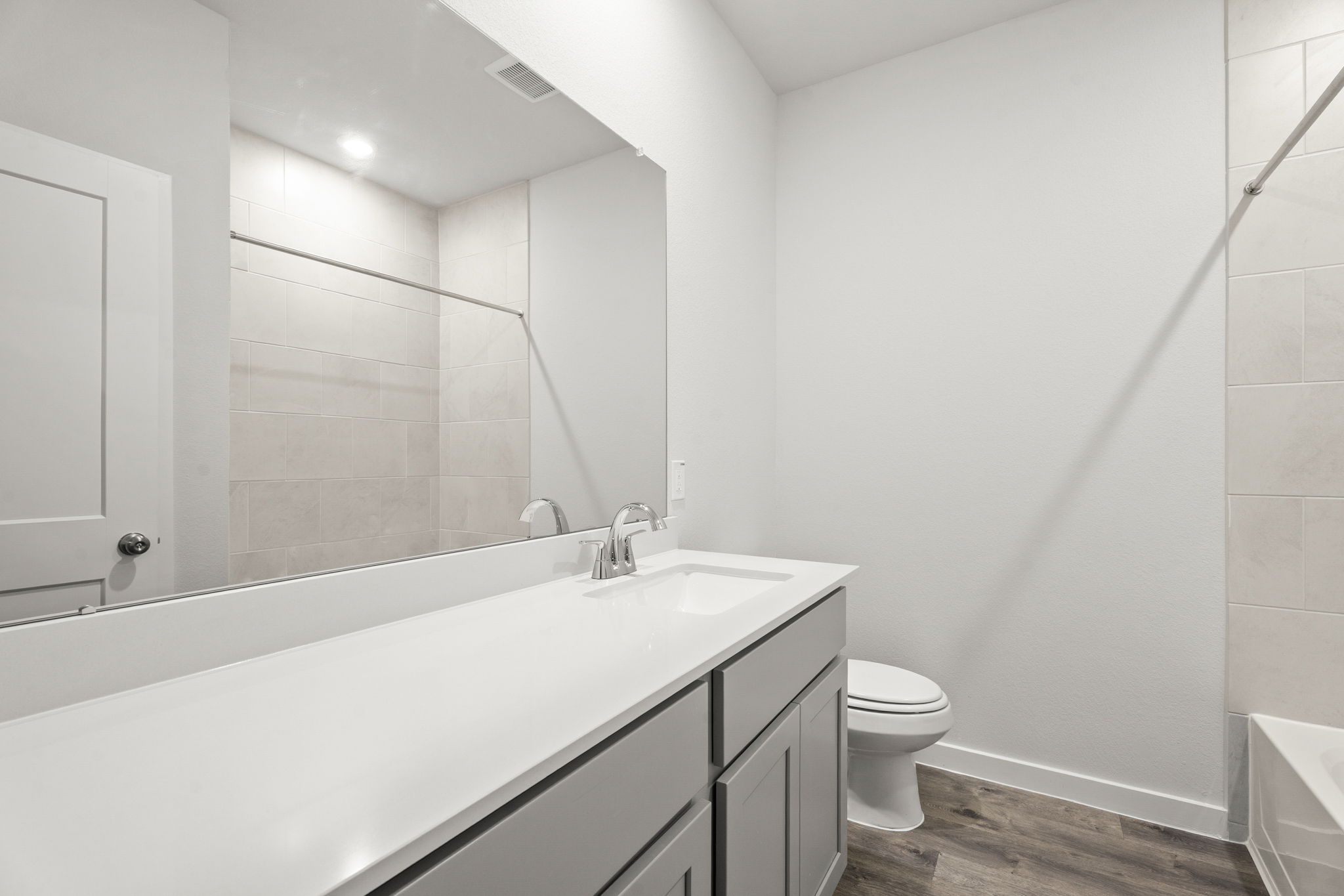 A bathroom with a tub toilet and sink.