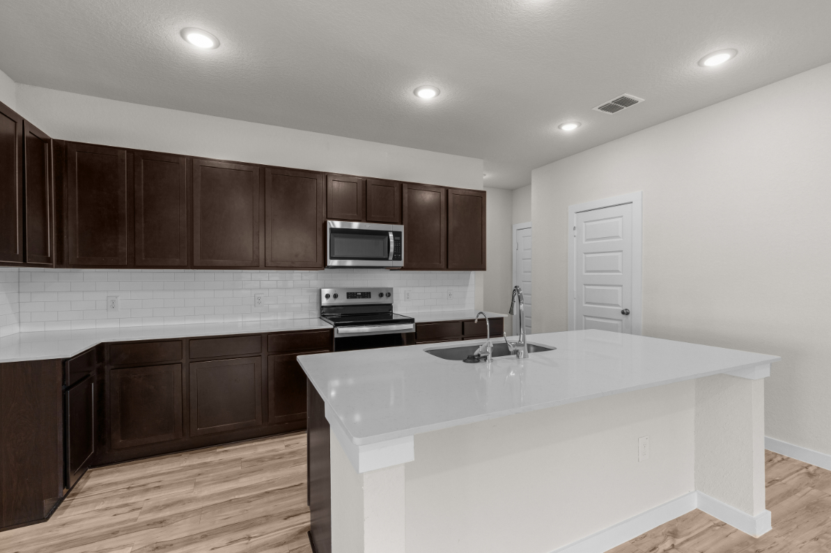 A kitchen with wooden cabinets.