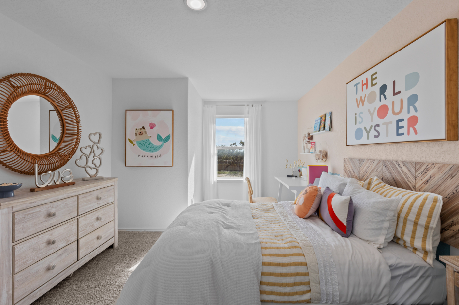 A bedroom with a large mirror.