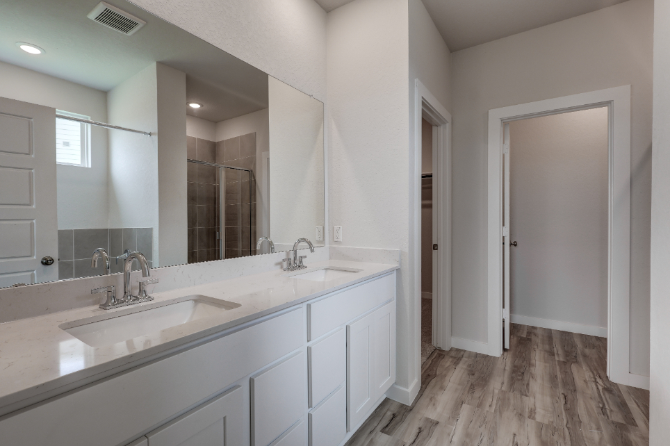 A bathroom with a large mirror.