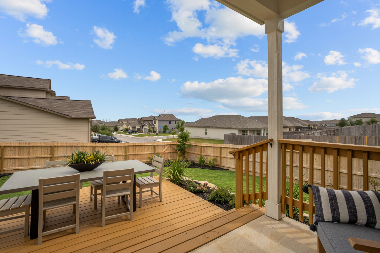 A deck with a table and chairs on it and a pole with a pole in the middle.