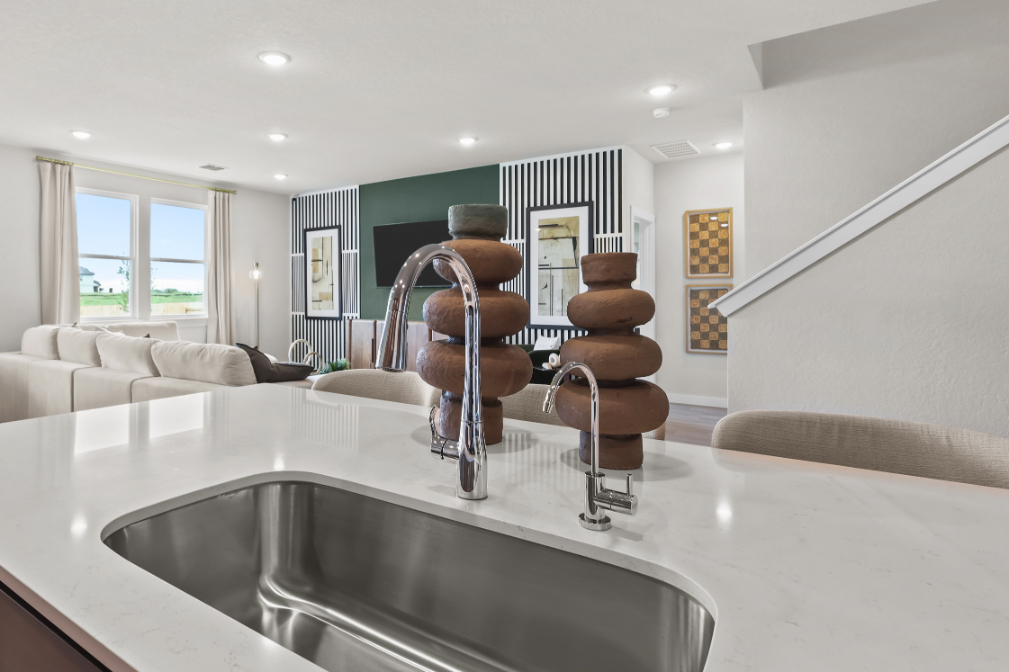 A large white table with a glass top and a large glass bowl on it.