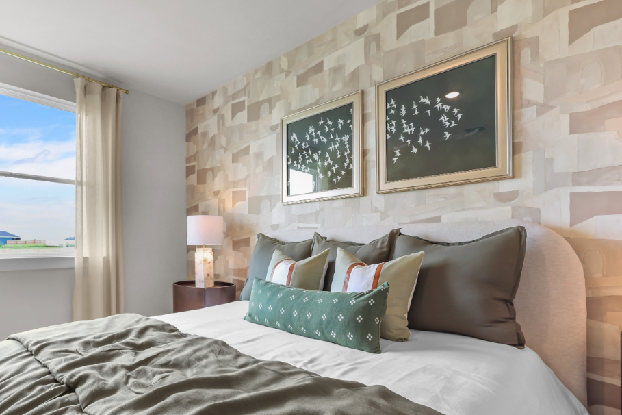A bed with pillows and a lamp.