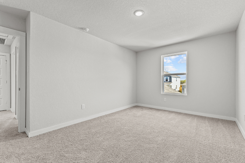 A room with a painting on the wall.