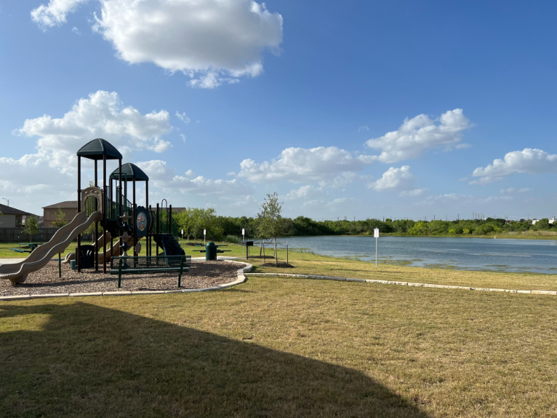 A large metal structure next to a body of water.