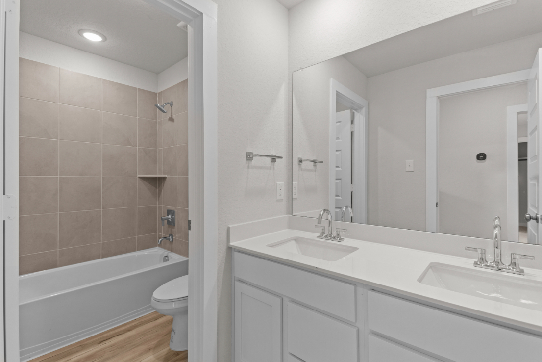 A bathroom with a tub sink and toilet.