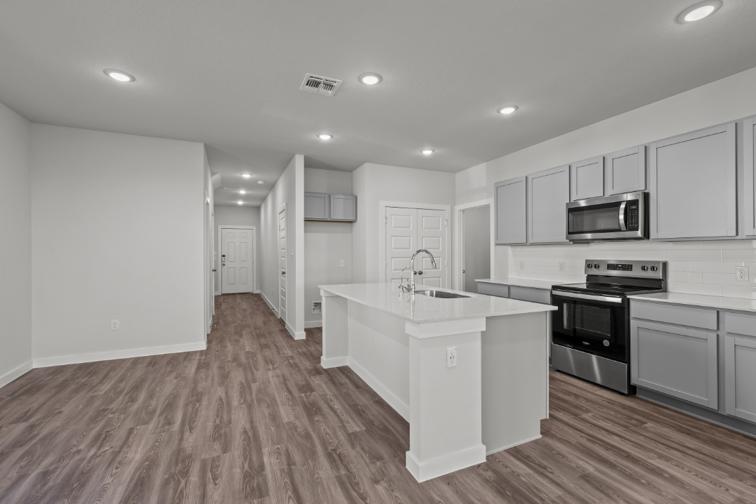 A kitchen with white cabinets.