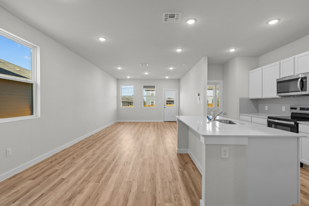 A kitchen with white cabinets.