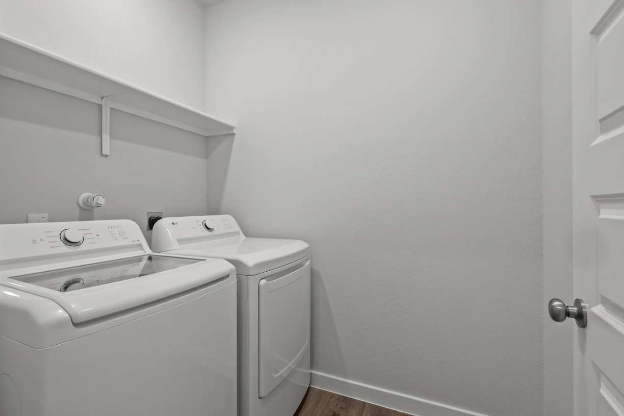 A washing machine in a room.